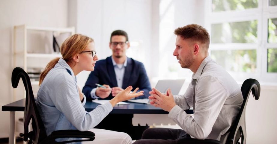 Couple arguing while meeting with Family lawyer